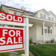 Sold Home For Sale Sign and New Home