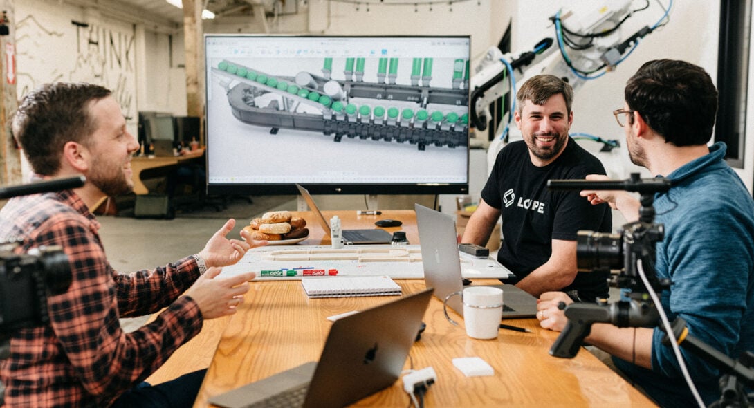 Loupe team having a discussion around a table