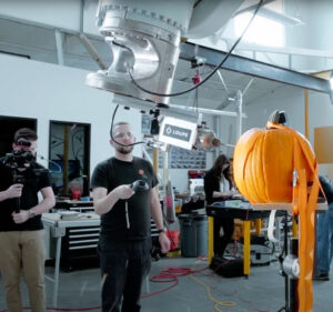 Loupe team member carving a pumpkin with a robot