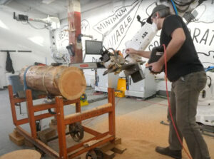 Loupe team member testing a robot saw on a large log