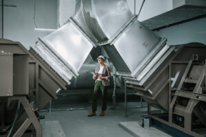 Systems West team member assessing ducting components