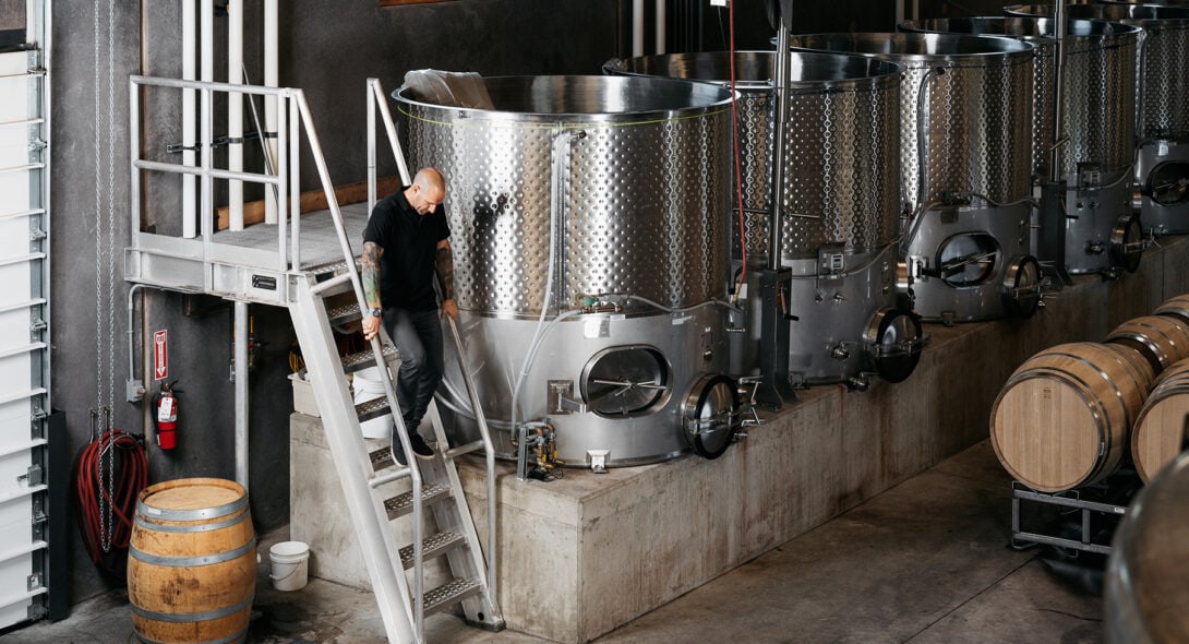 President Deven Paolo descending a metal staircase produced by Solid Form at a winery