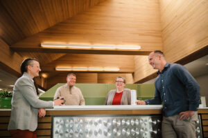 Systems West team members laughing and chatting in the office