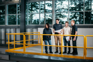Team members socializing above shop floor